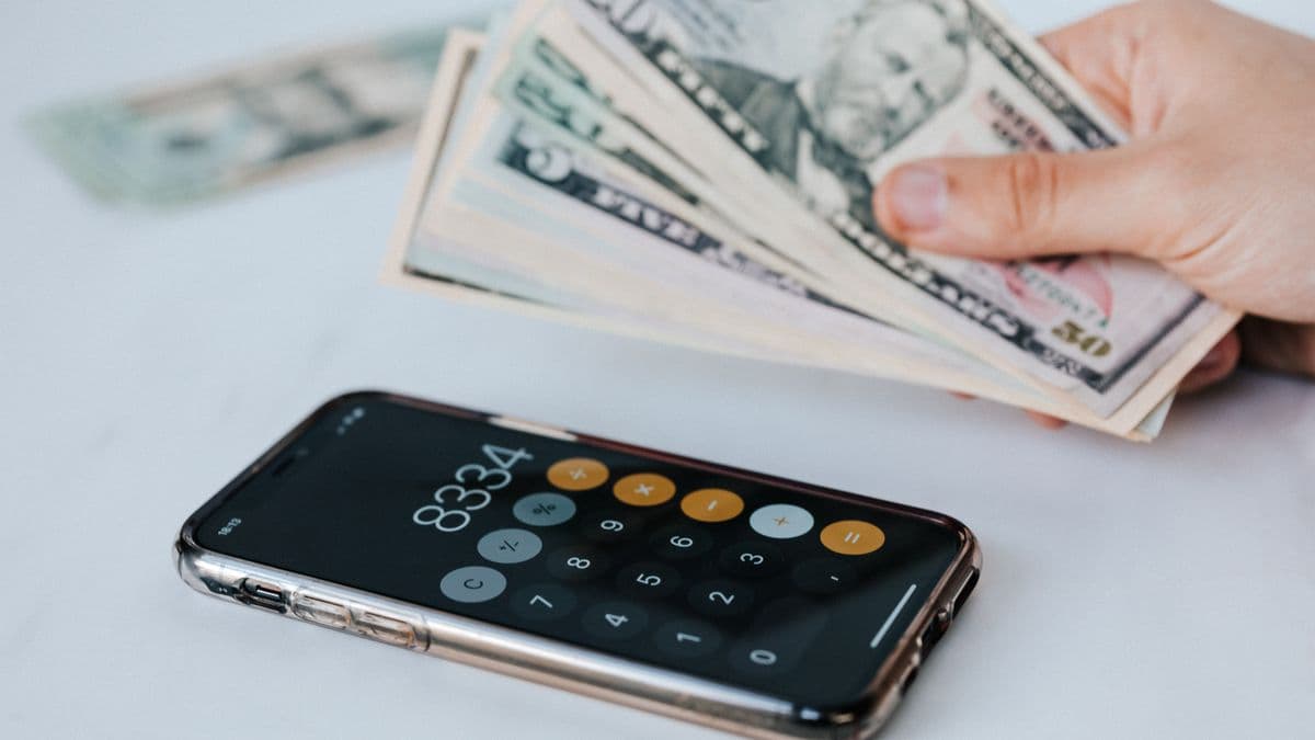 A calculator and cash for cutting mobile money fees
