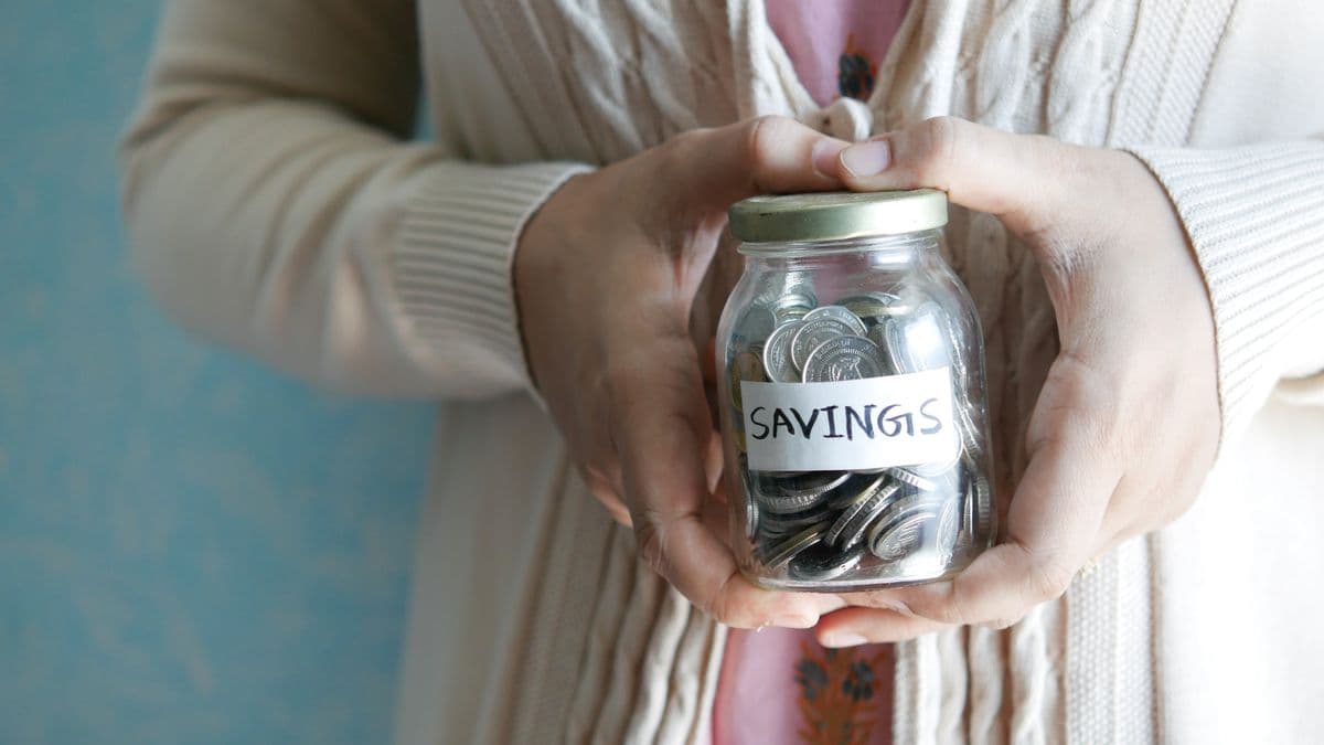 Saving coins in a jar for school fees