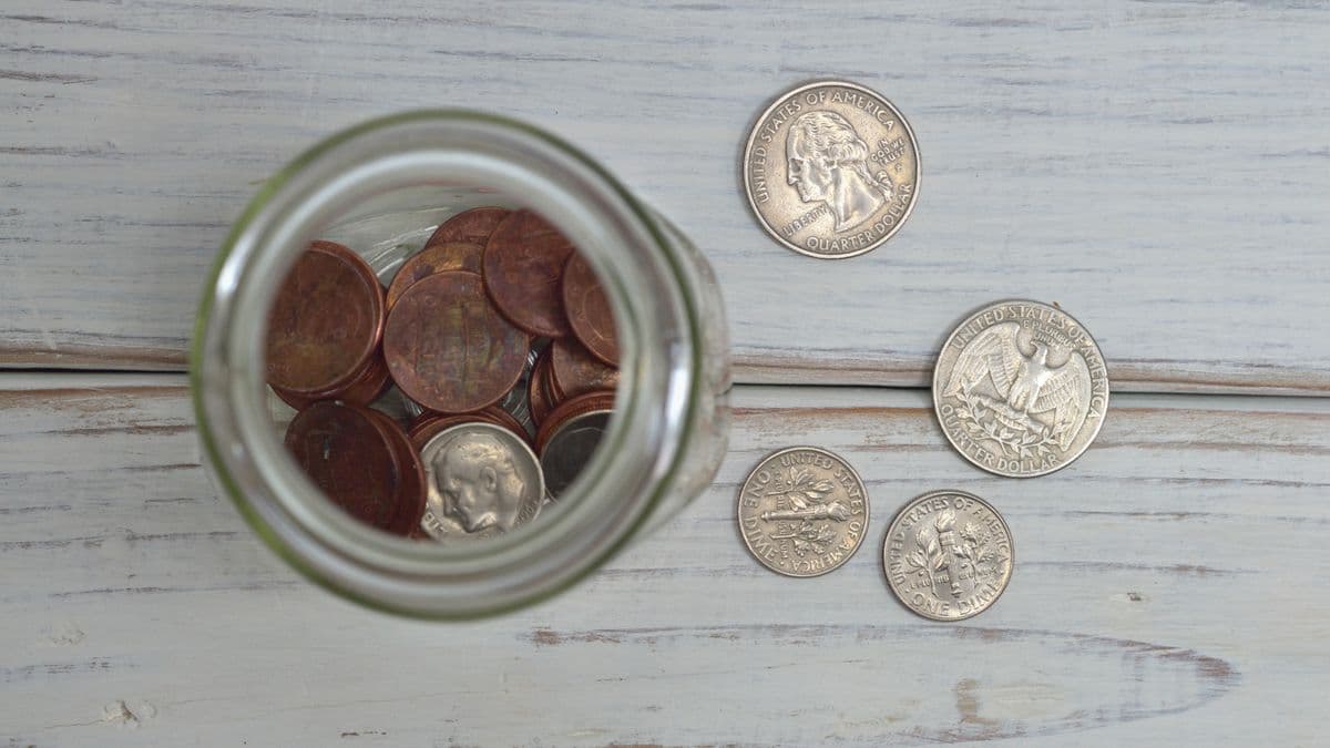 Coins on a table representing saving on a low income