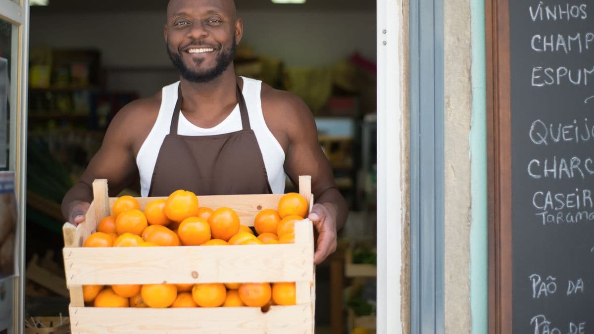 A small-business vendor with stock and produce