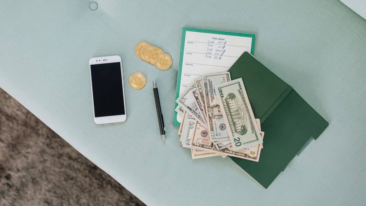 A smartphone with money representing mobile loan debt
